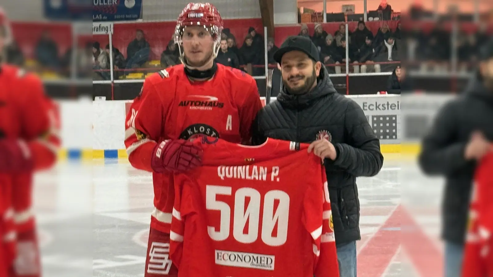 Stürmer Philipp Quinlan vom EHC Klostersee zusammen mit Vorstandsmitglied Ferdinand Bacher bei der Ehrung für das 500. Pflichtspiel. (Foto: smg)