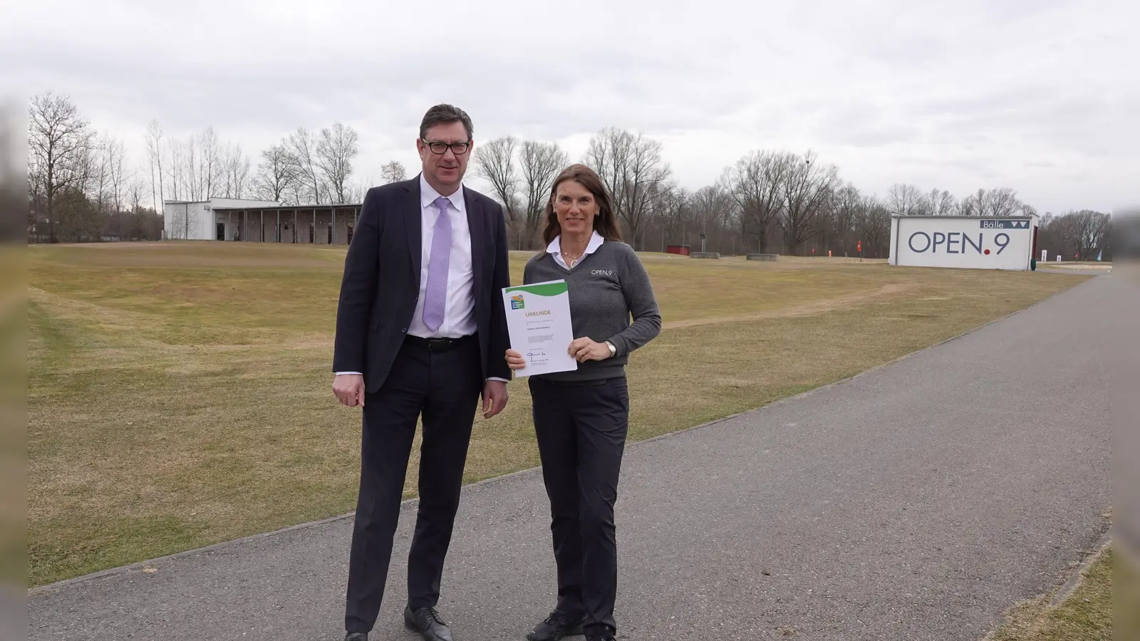 Landrat des Landkreises Erding Martin Bayerstorfer (li.) überreicht die Umwelt- und Klimapakt Bayern Urkunde an Daniela Schön-Horder, geschäftsführende Gesellschafterin von OPEN.9. (Foto: LRA Erding)